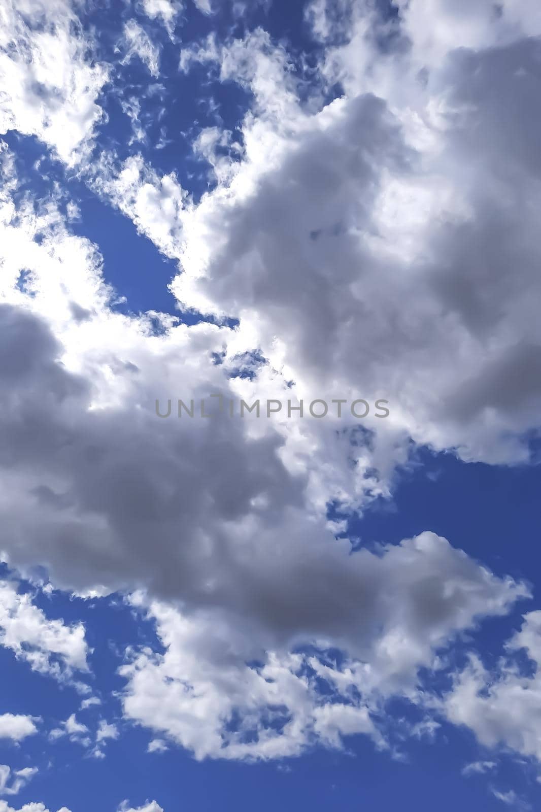Bottom view of a blue sky with white clouds