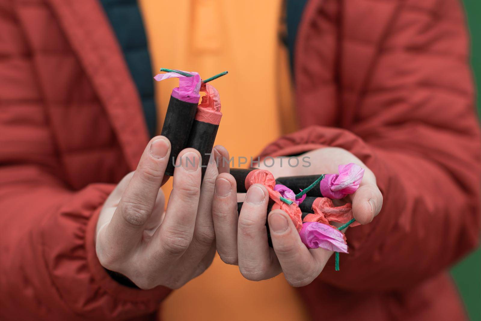 Man Holding Firecrackers in his Hand. Guy Getting Ready for New Year Fun - CloseUp Shot