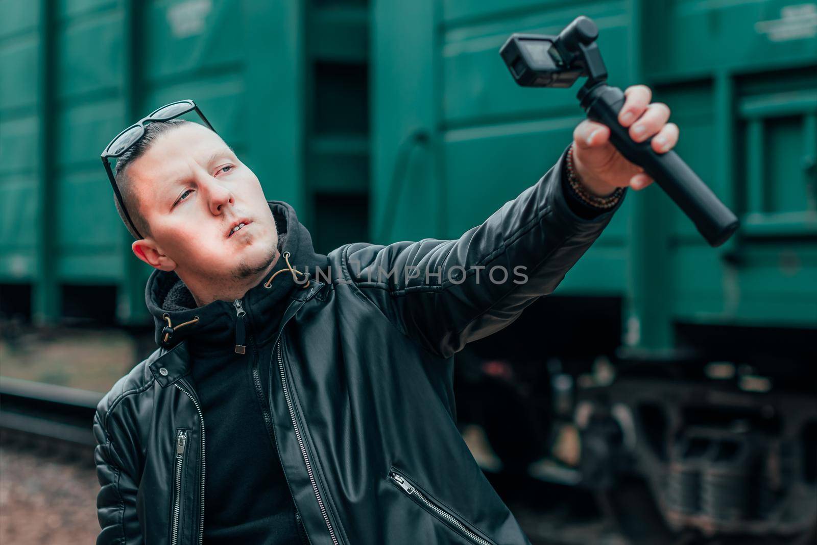 Handsome Guy Making Selfie Using Action Camera at Railway by InfinitumProdux