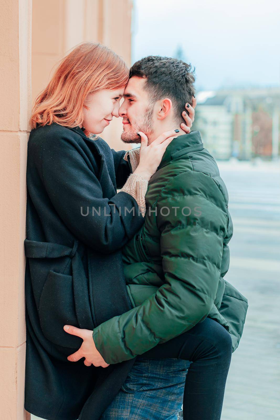 Happy Loving Couple Smiling and Hugging on the Street. Two Happy People Love Story - Medium Shot Portrait