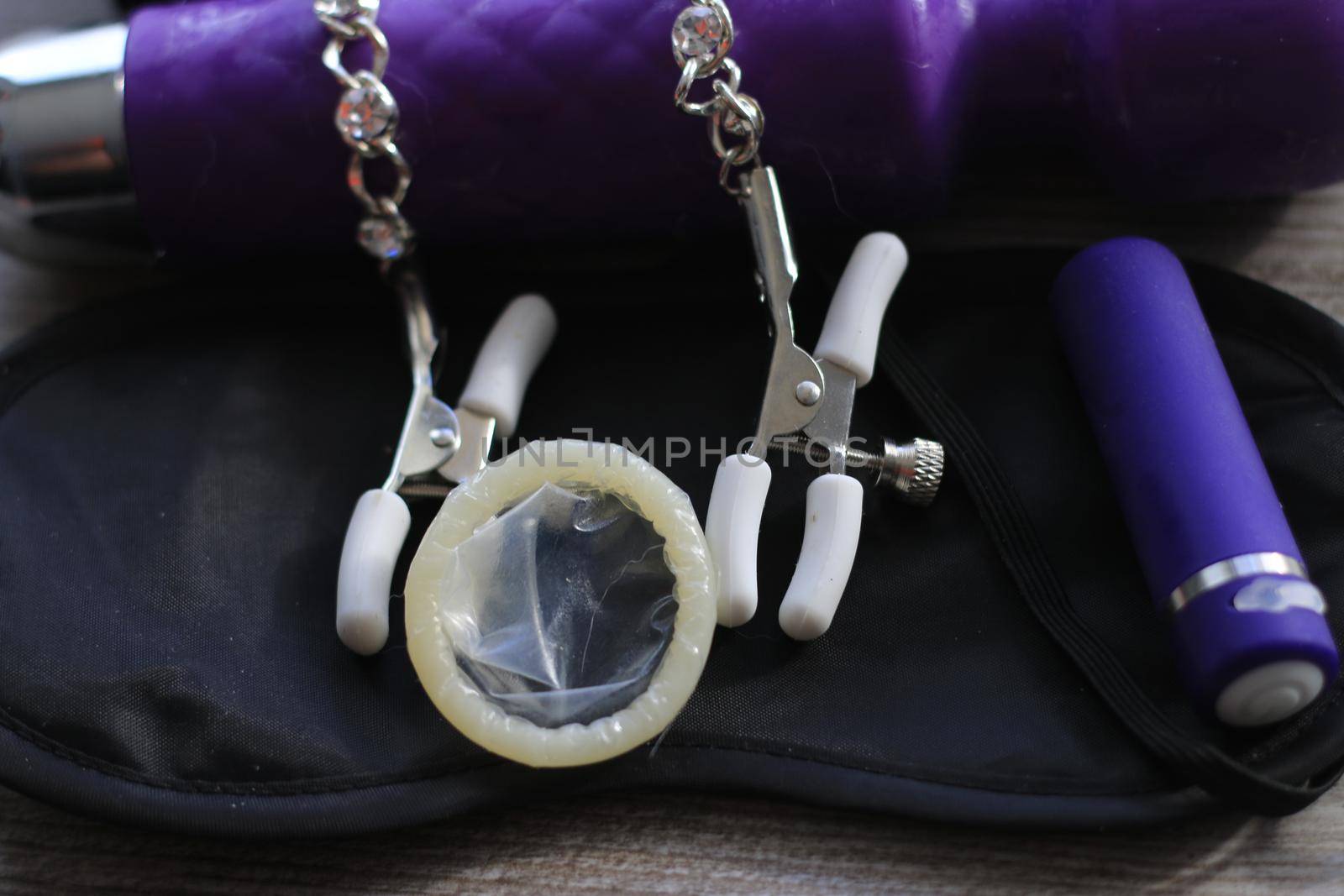 BDSM themed images showing a large dildo, nipple clamps, restraints, eye covers, and a condom by mynewturtle1
