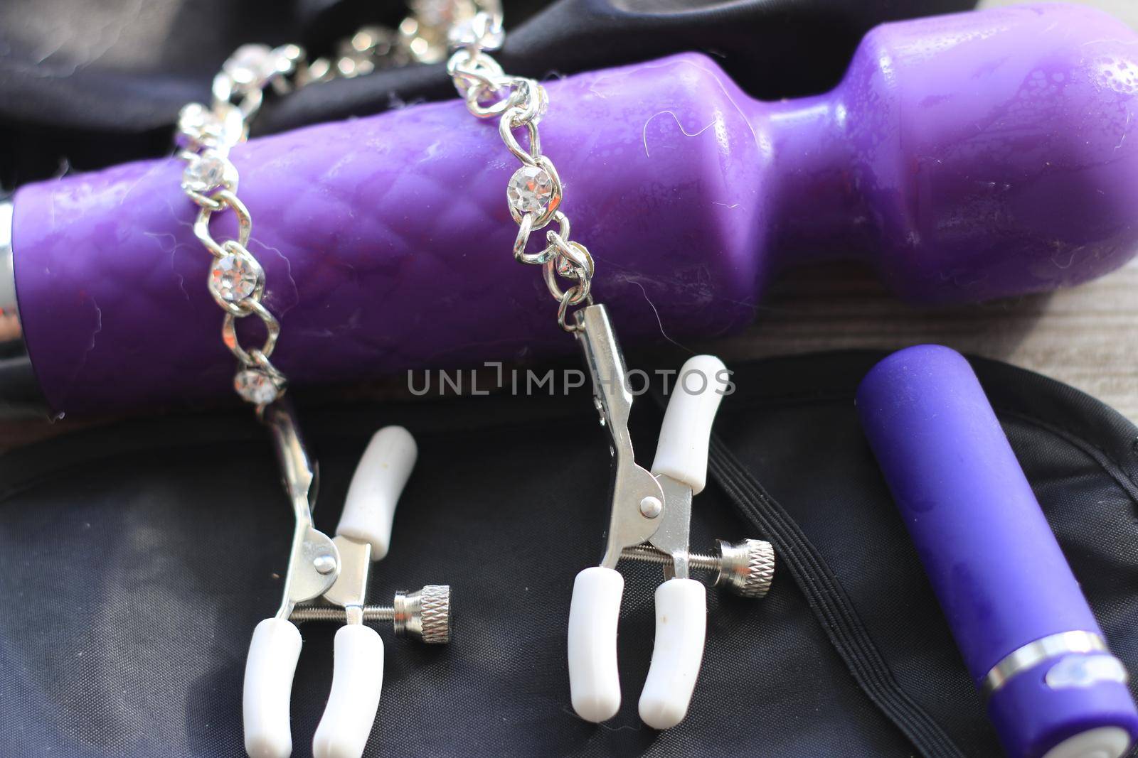 BDSM themed images showing a large dildo, nipple clamps, restraints, eye covers, and a condom. High quality photo