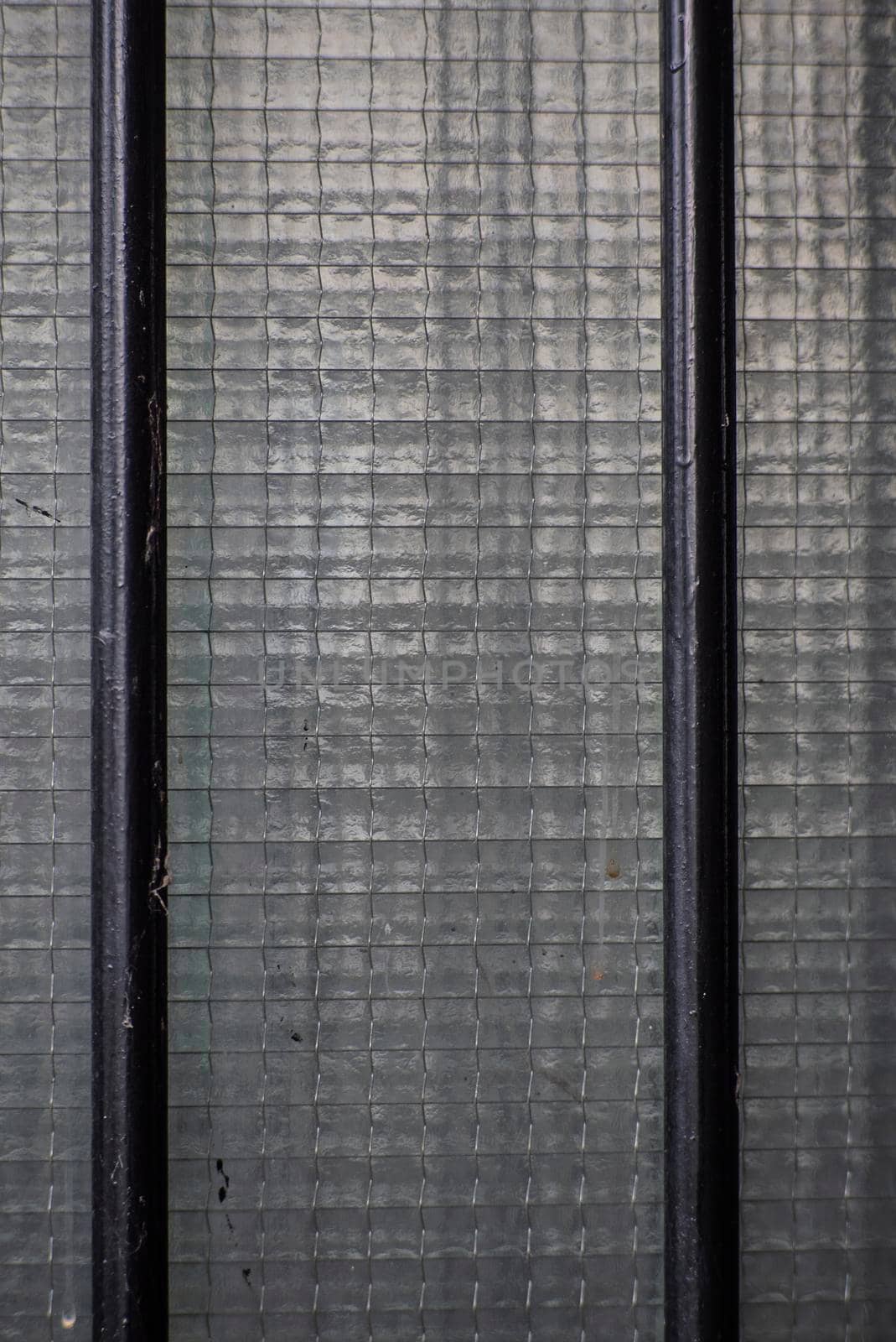 Macro detail of Armored glass window in a old door