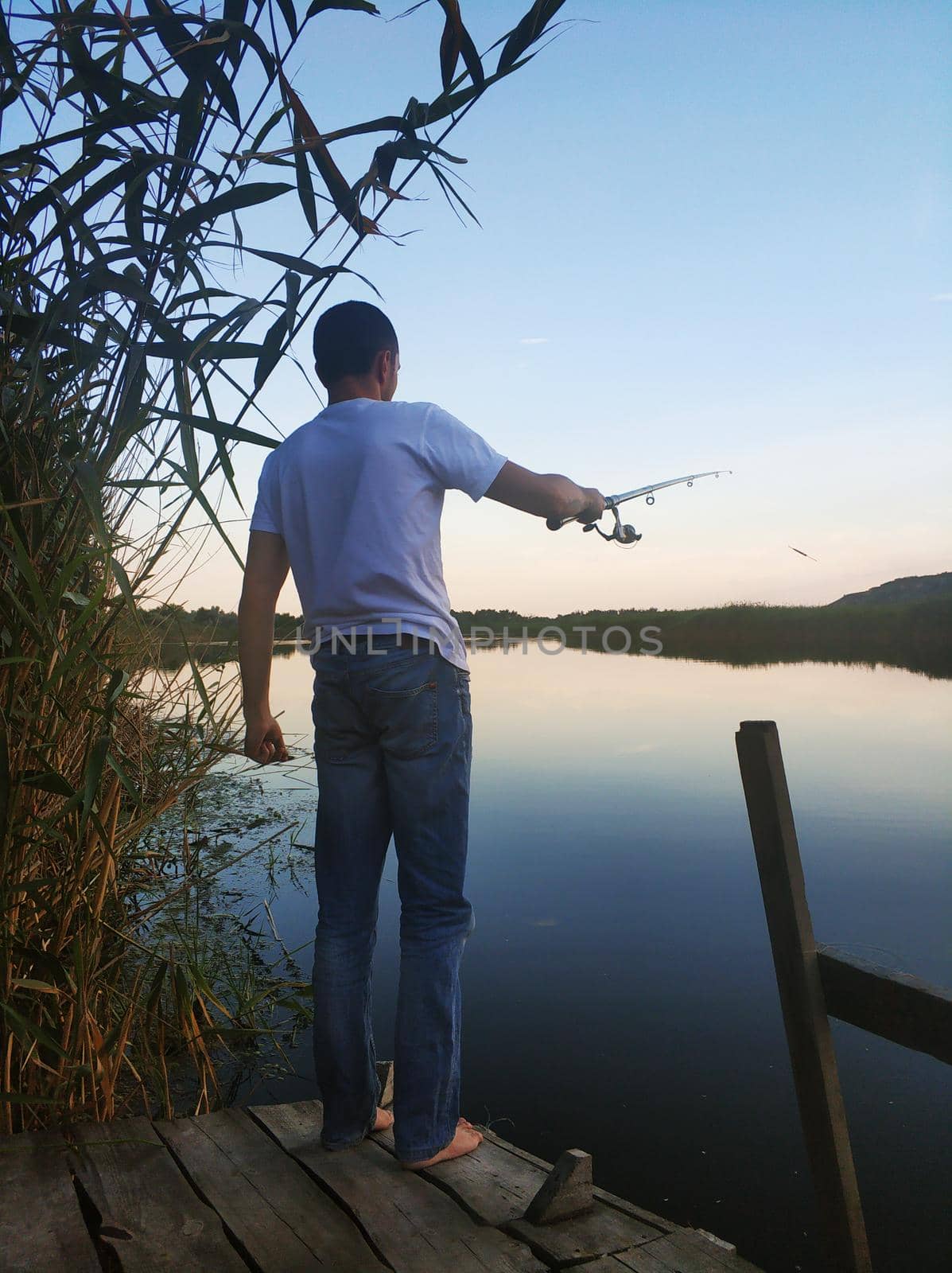 Quiet fishing spot by the river. View of the river from the bank.