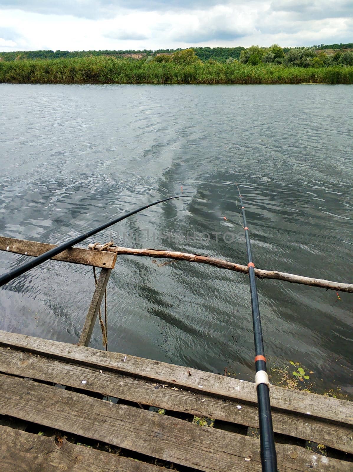 Quiet fishing spot by the river. View of the river from the bank.