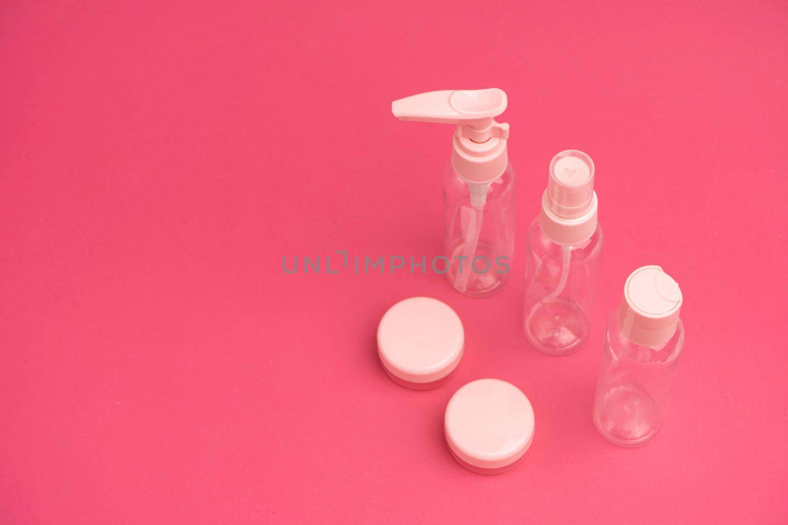 A kit of plastic containers for transportation of shampoos, creams and cosmetics in travel.