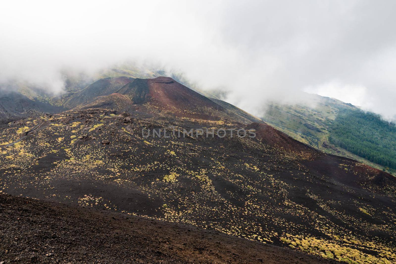 View of Etna volcano craters among the clouds near Rifugio Sapienza. Sicily, Italy