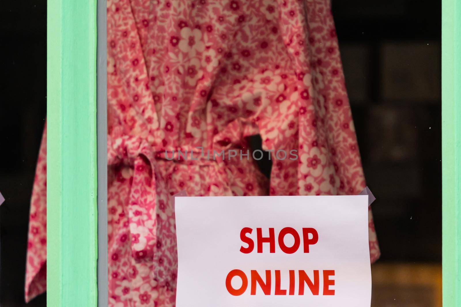 Shop online sign on high street shop window during Covid-19 lockdown by mauricallari
