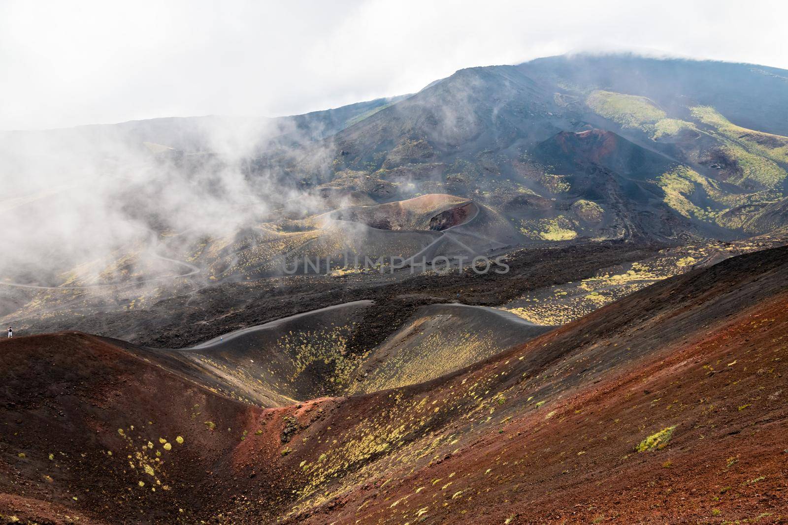 View of Etna volcano craters among the clouds near Rifugio Sapienza. Sicily, Italy