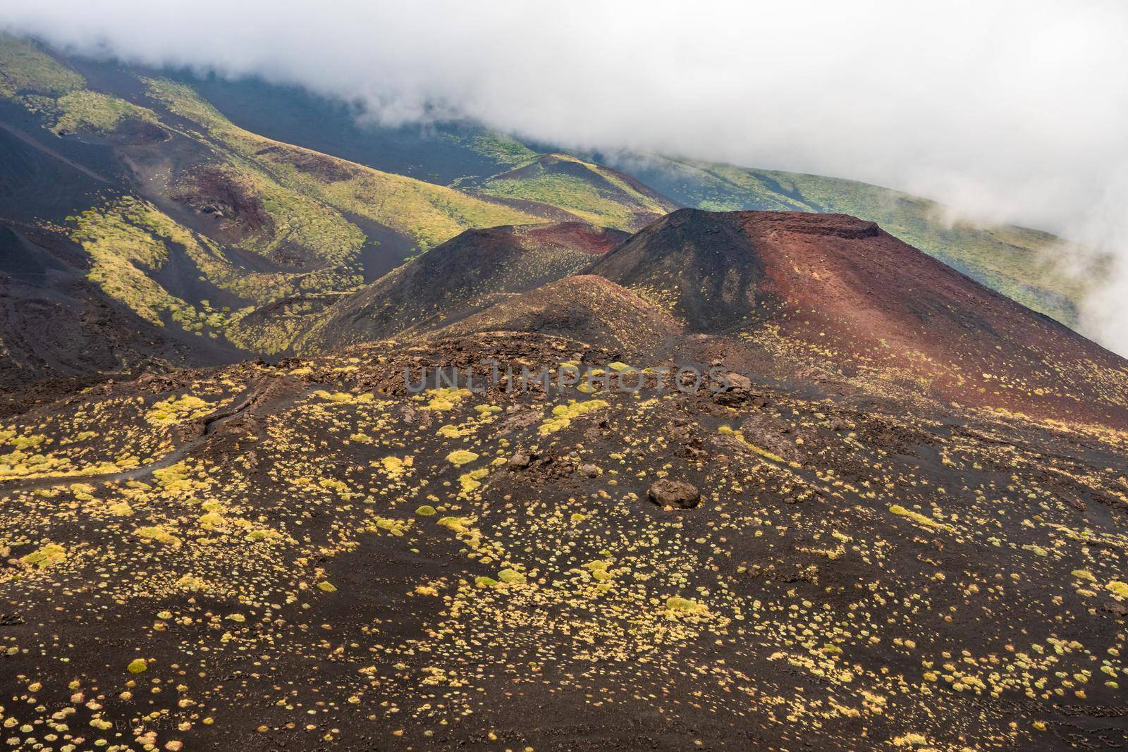 View of Etna volcano craters among the clouds near Rifugio Sapienza. Sicily, Italy