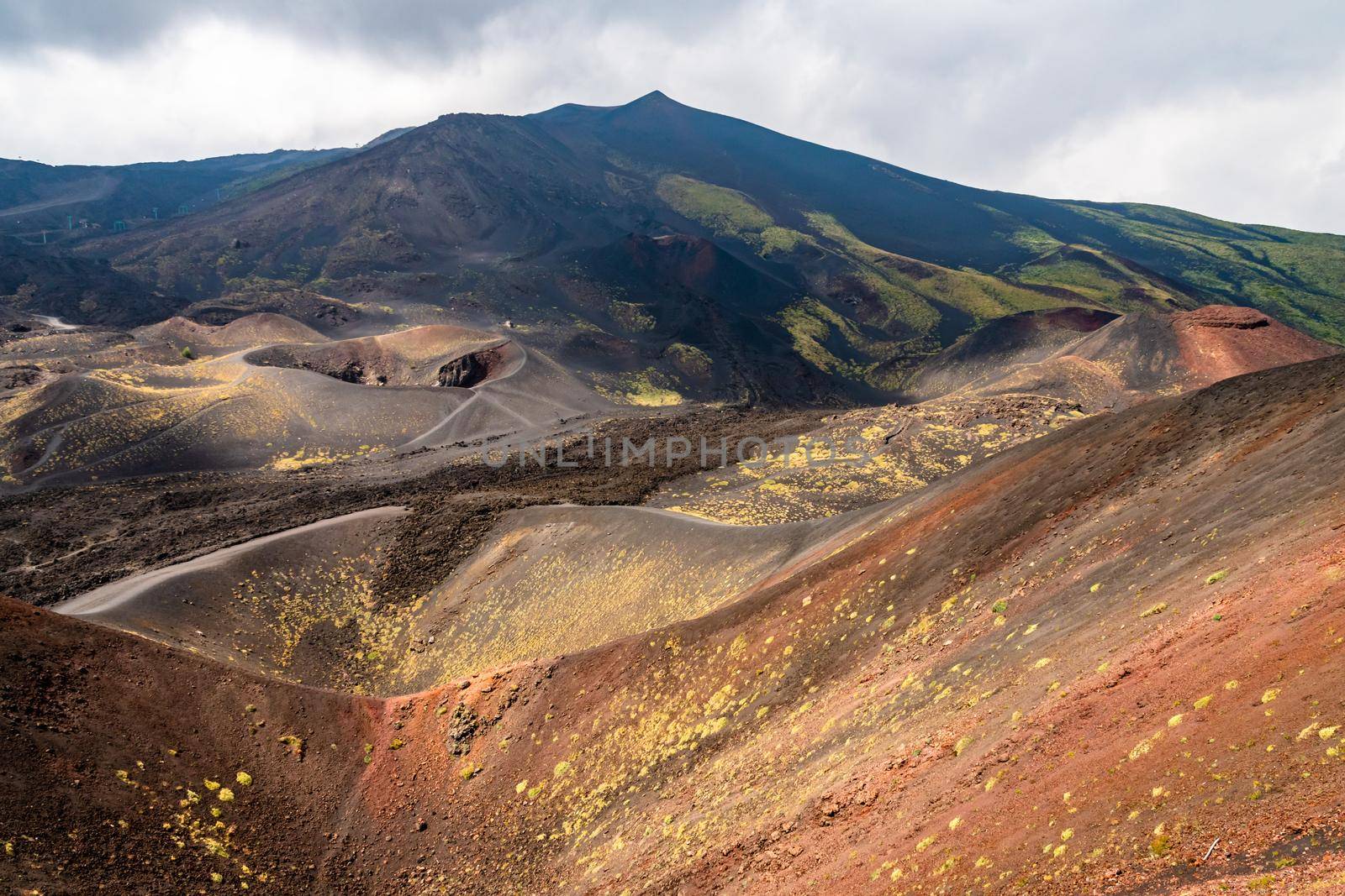 View of Etna volcano craters among the clouds near Rifugio Sapienza. Sicily, Italy