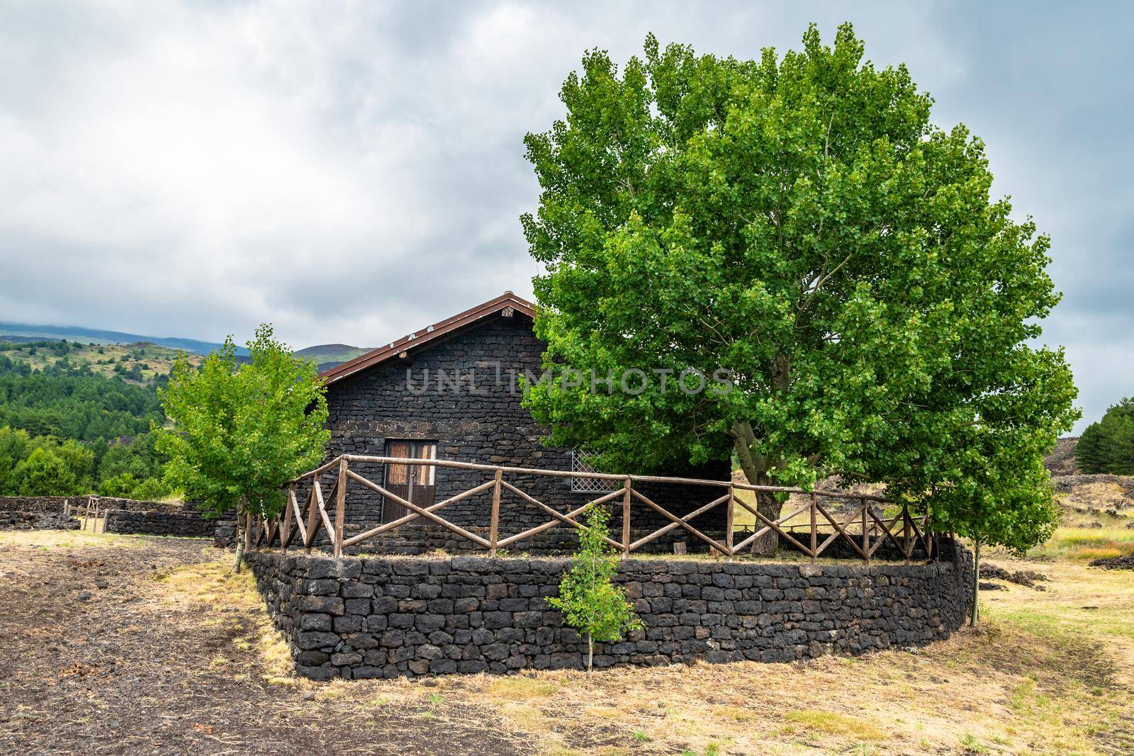 Summer view of Carpinteri refuge on Mount Etna built with lava stones, Sicily. Italy