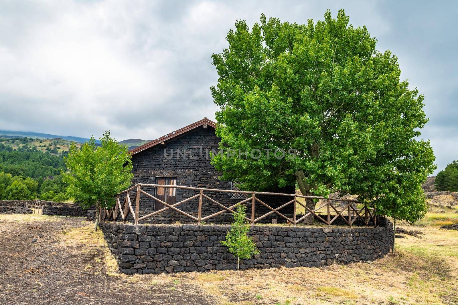 Summer view of lava stone Carpinteri refuge on Mount Etna, Sicily by mauricallari