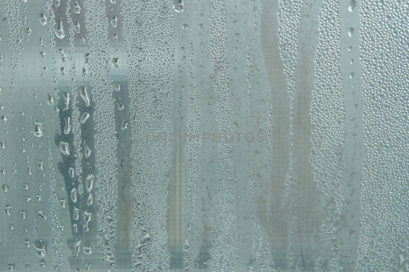 Bright grey color glassy texture, with water drops on it. Water drop glassy background