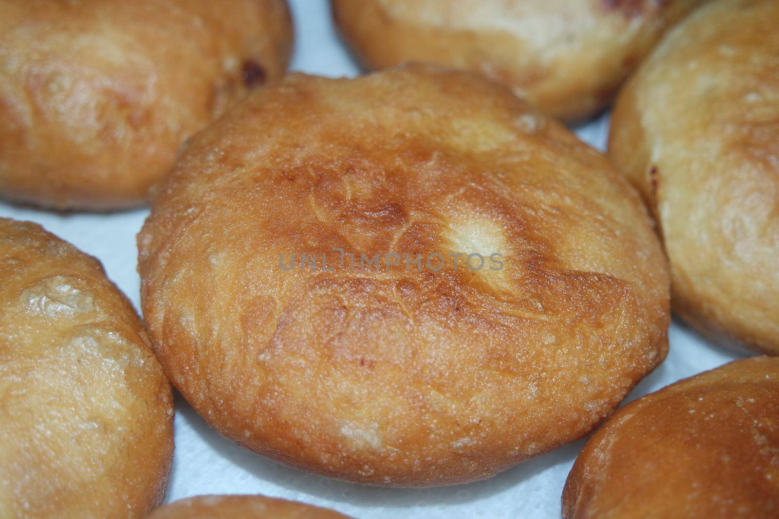 Closeup view of homemade tasty potato bread rolls bun placed over white tissue paper.