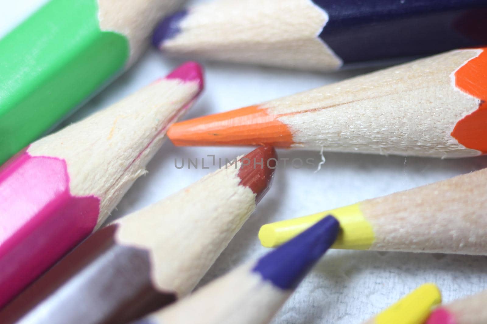 Close-up view of bright colored multicolor pencils on black background