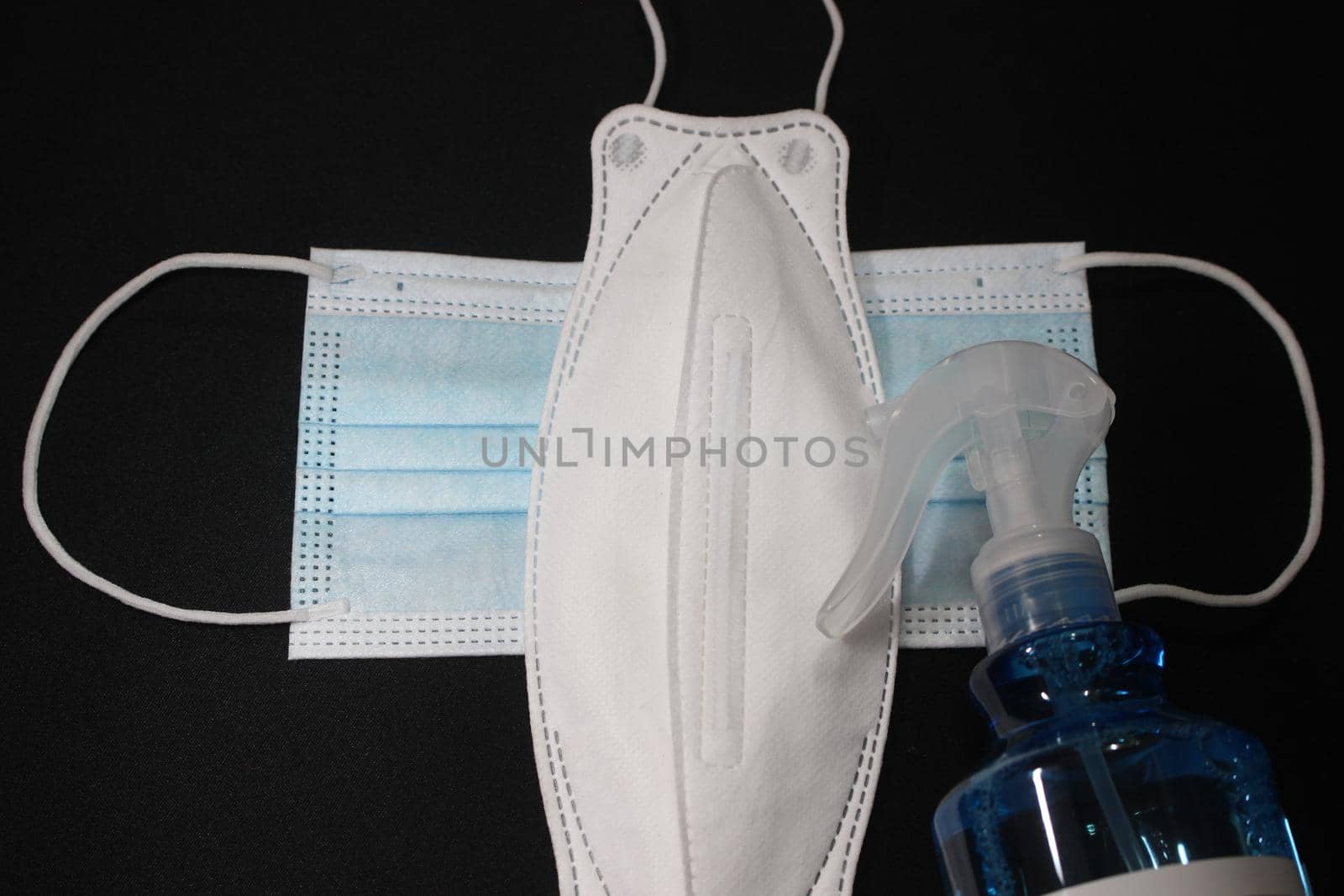 blue color cloth face mask with hand sanitizer bottle by Photochowk