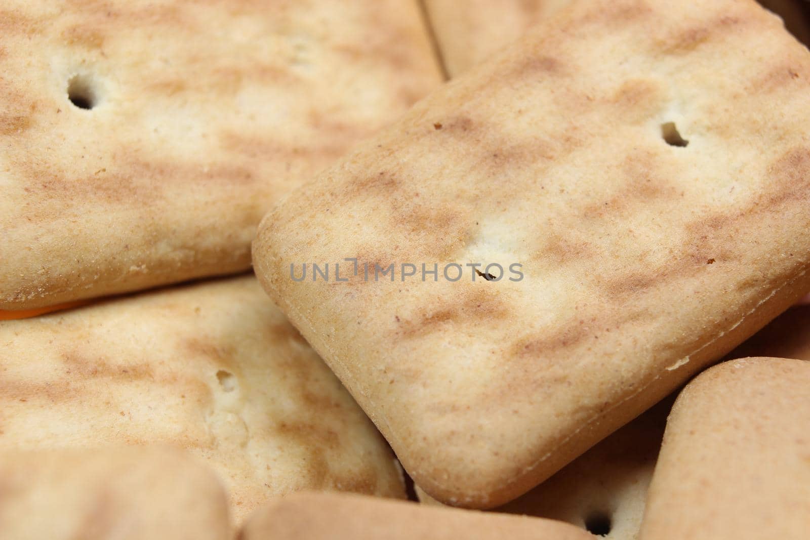 Close up top view of of biscuit cookies. Close up view rectangular biscuits with small pores