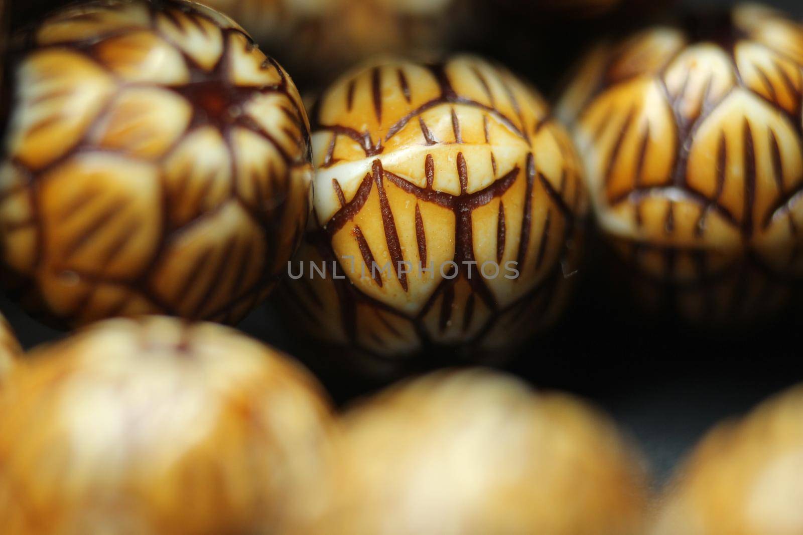 Beautiful wooden prayer beads or rosary with a striped background by Photochowk