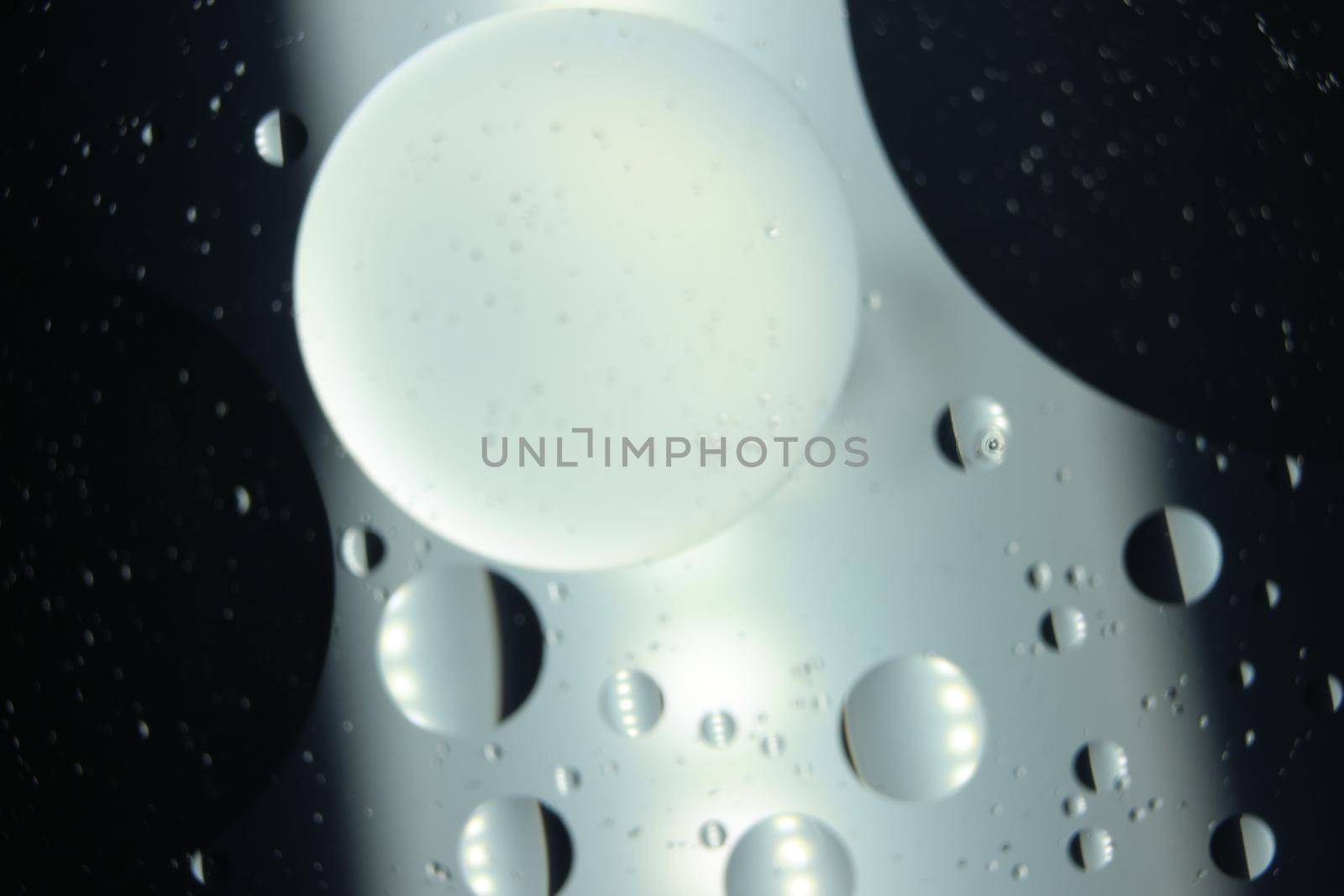 abstract macro background of oil circles floating over water surface . by Photochowk