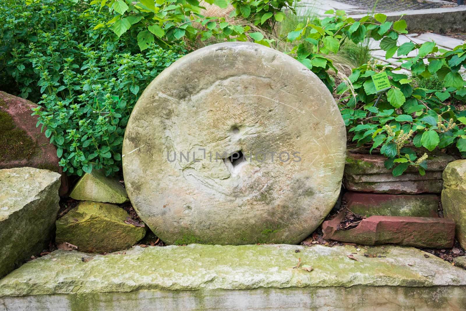 Closeup shot of an old millstone outside