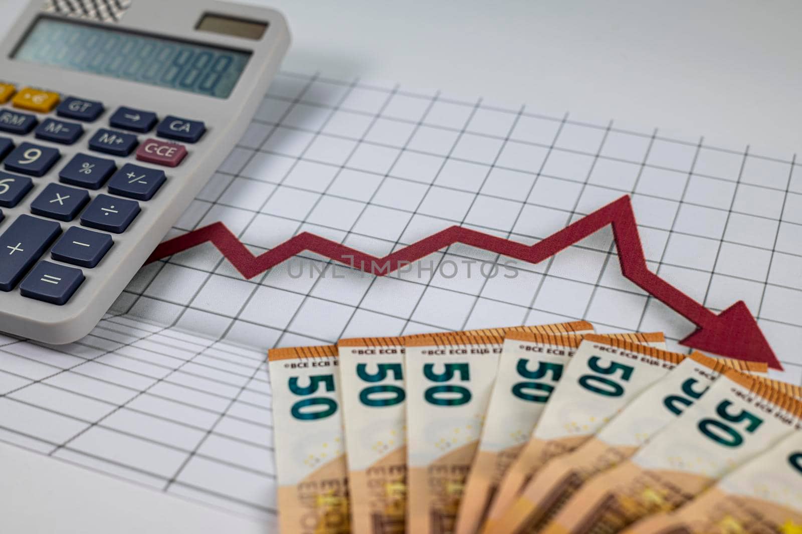 50 euro banknotes with graphs and calculator on white background