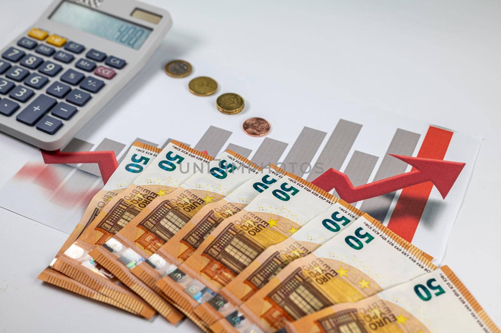 50 euro banknotes with graphs and calculator on white background
