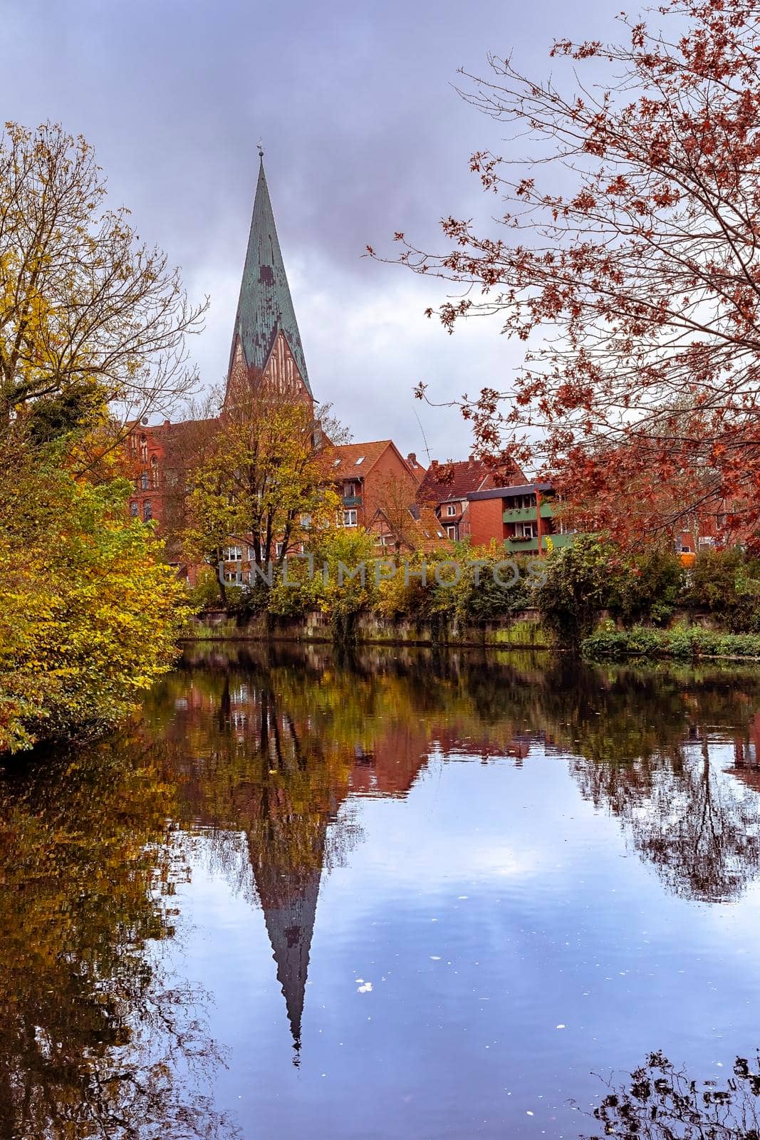 Luneburg, Germany, View of St. Johanniskirche with reflection in the river
