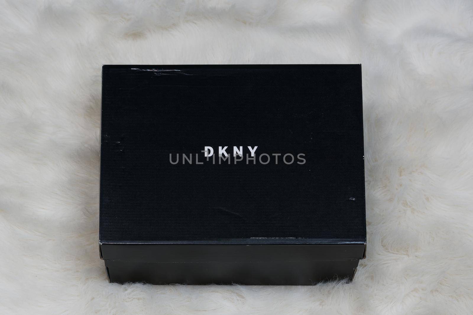 Display of order package containing a pair of DKNY fashion modern shoes with company logo.
