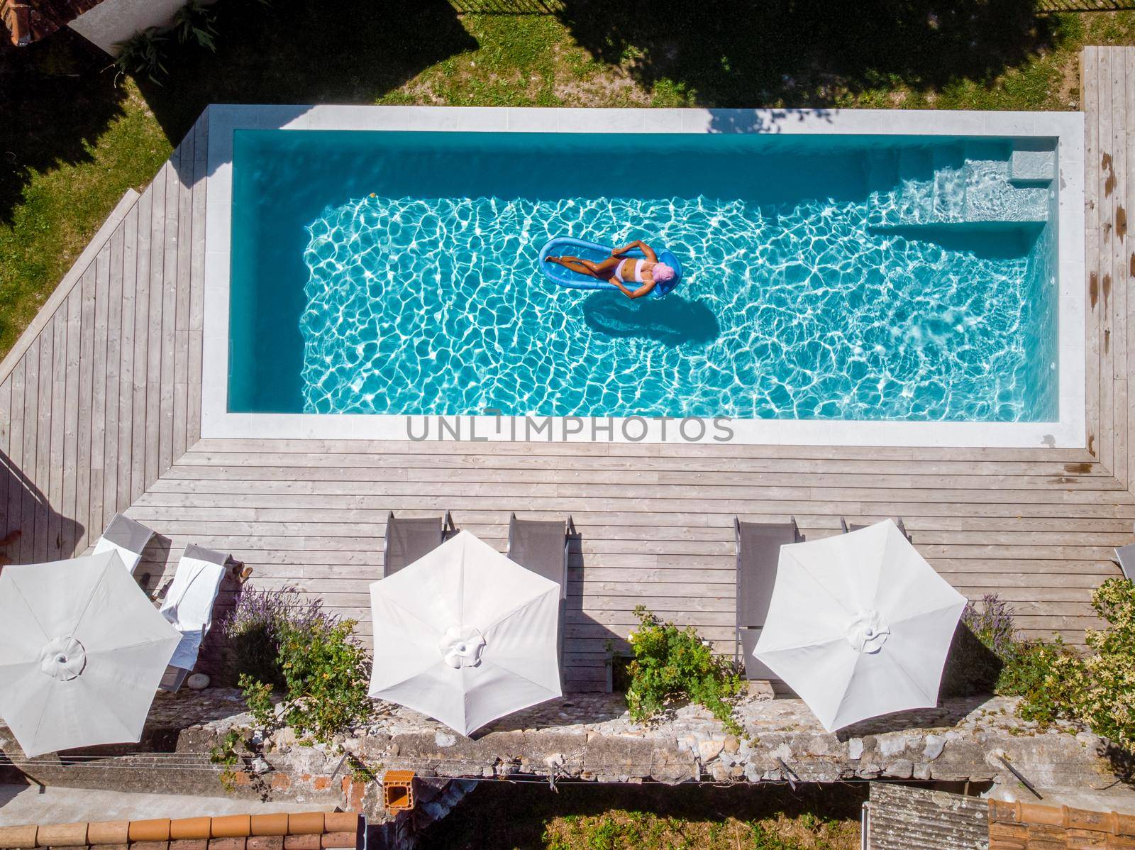 two person swim in the pool at the hotel. View from above, couple men and women in swimming pool of luxury vacation home in the Ardeche France Europe