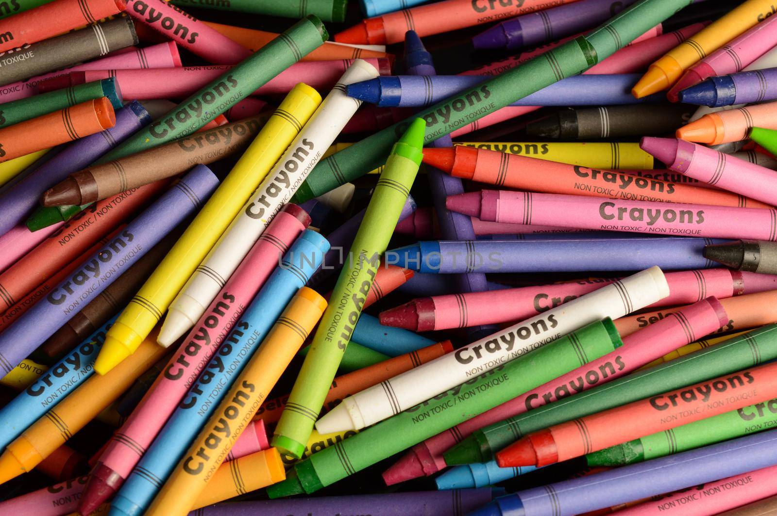 A macro shot of various crayons to make a full frame background image of vibrant colors.