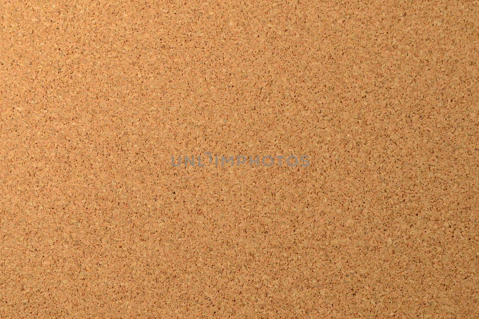 A full frame image of a clean corkboard to use as a background element.