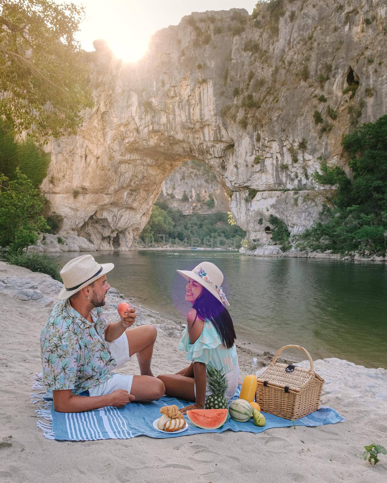 couple on vacation in the Ardeche France , young men and woman visiting Narural arch in Vallon Pont D'arc in Ardeche canyon in France by fokkebok