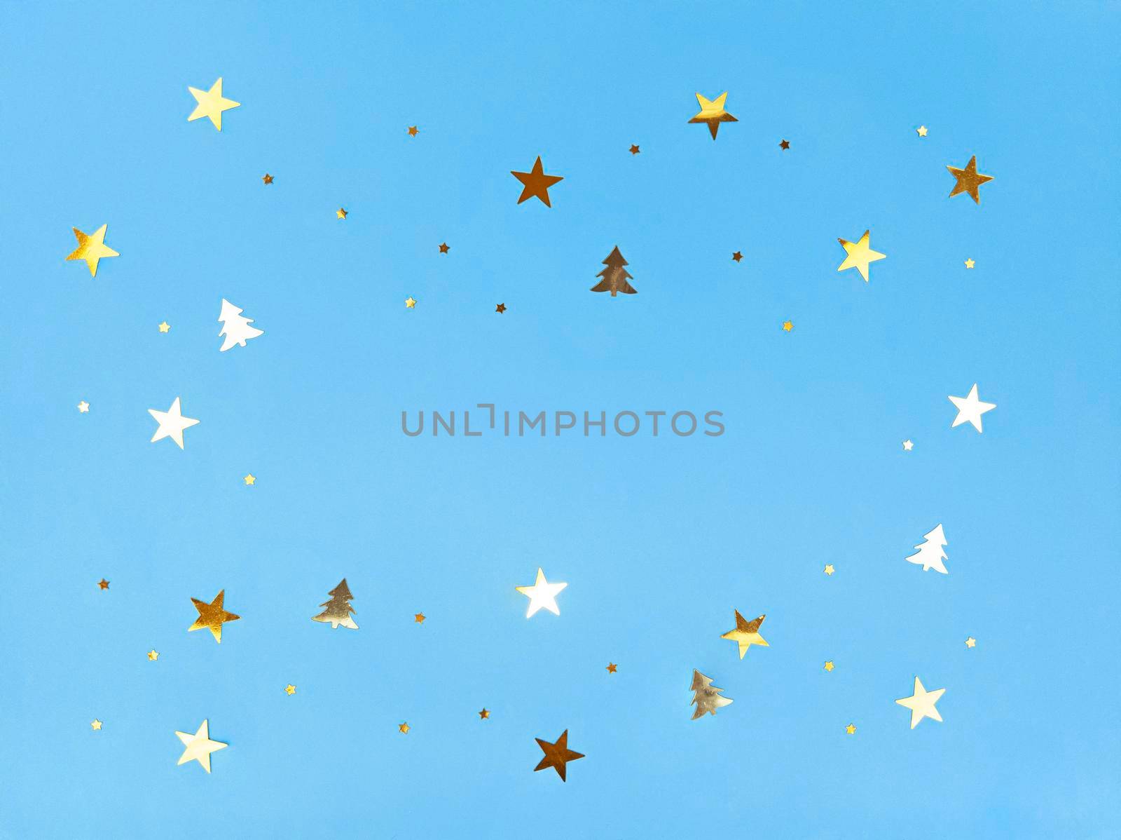 Confetti stars and trees sparkling on a blue background.