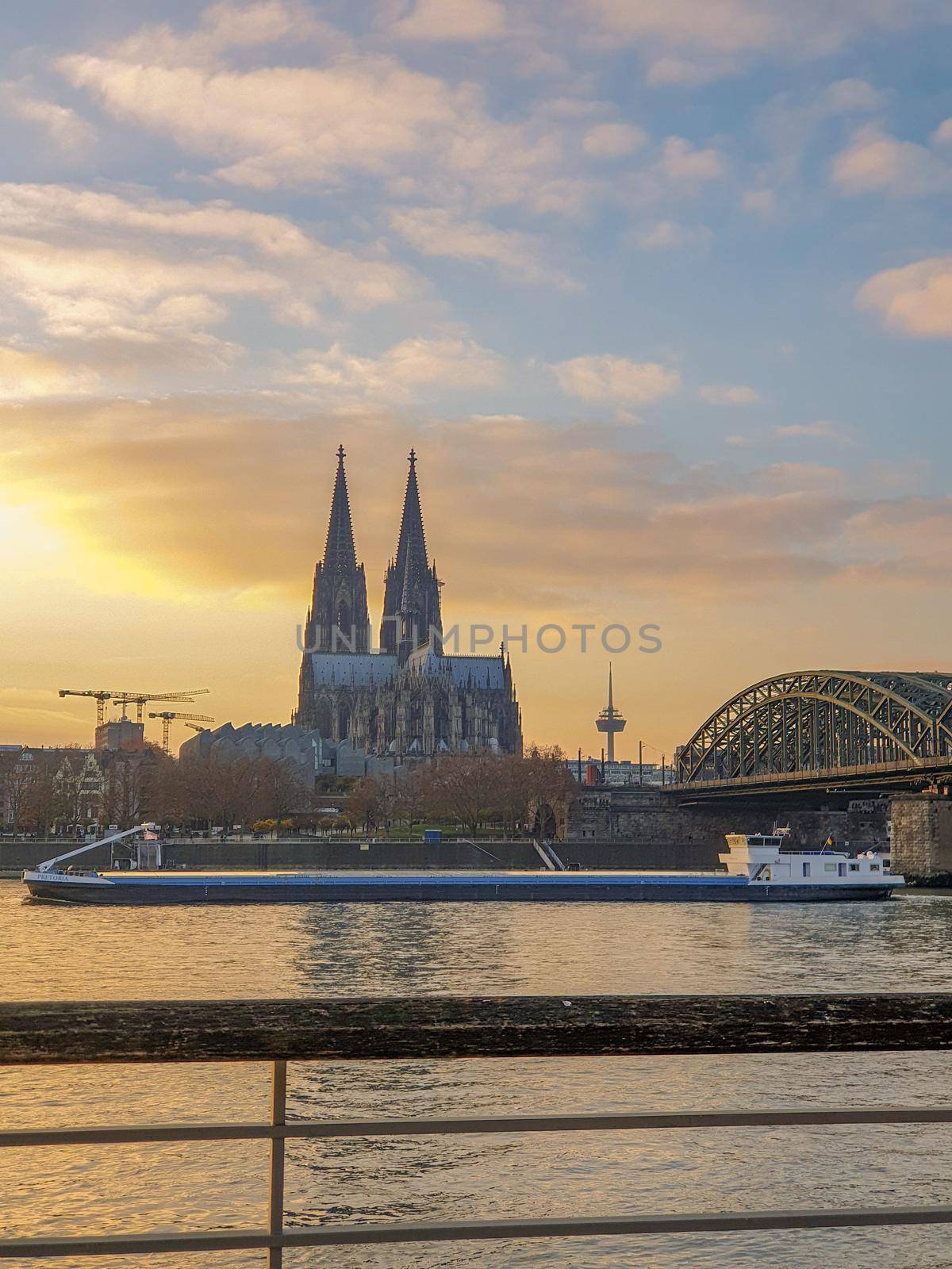 Cologne Germany alongside the rhein river during sunset with the huge Cathedral by fokkebok