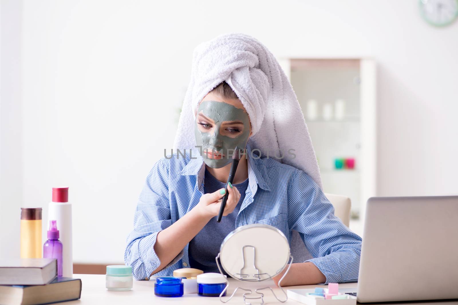Beauty blogger applying mask and posting to internet blog by Elnur