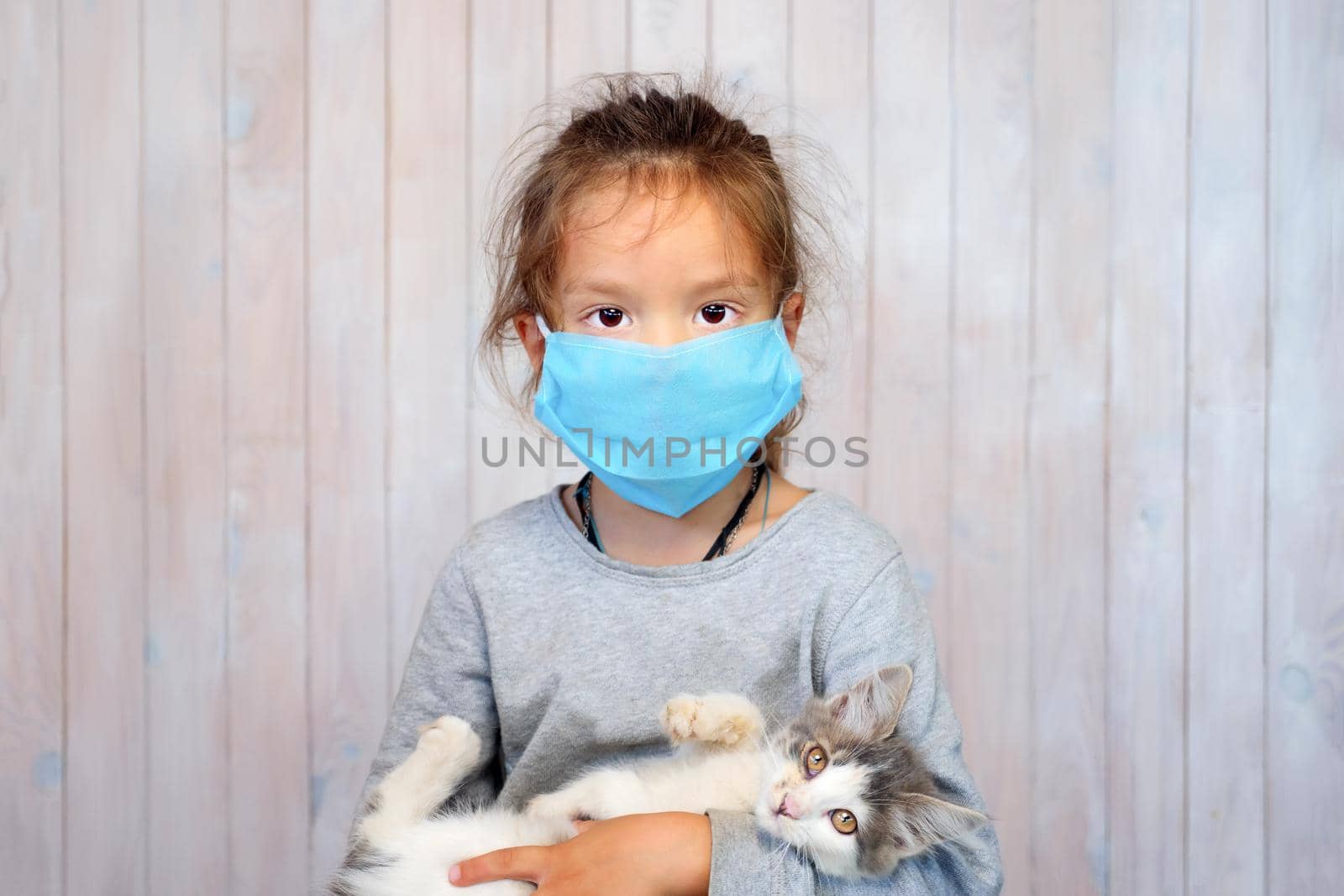 Corona virus and sad kid. Generation in mask. Portrait baby girl in mask. Child during pandemic. Little girl and Coronavirus. Sad little girl in mask. Small girl and quarantine. Unhappy child in mask by synel