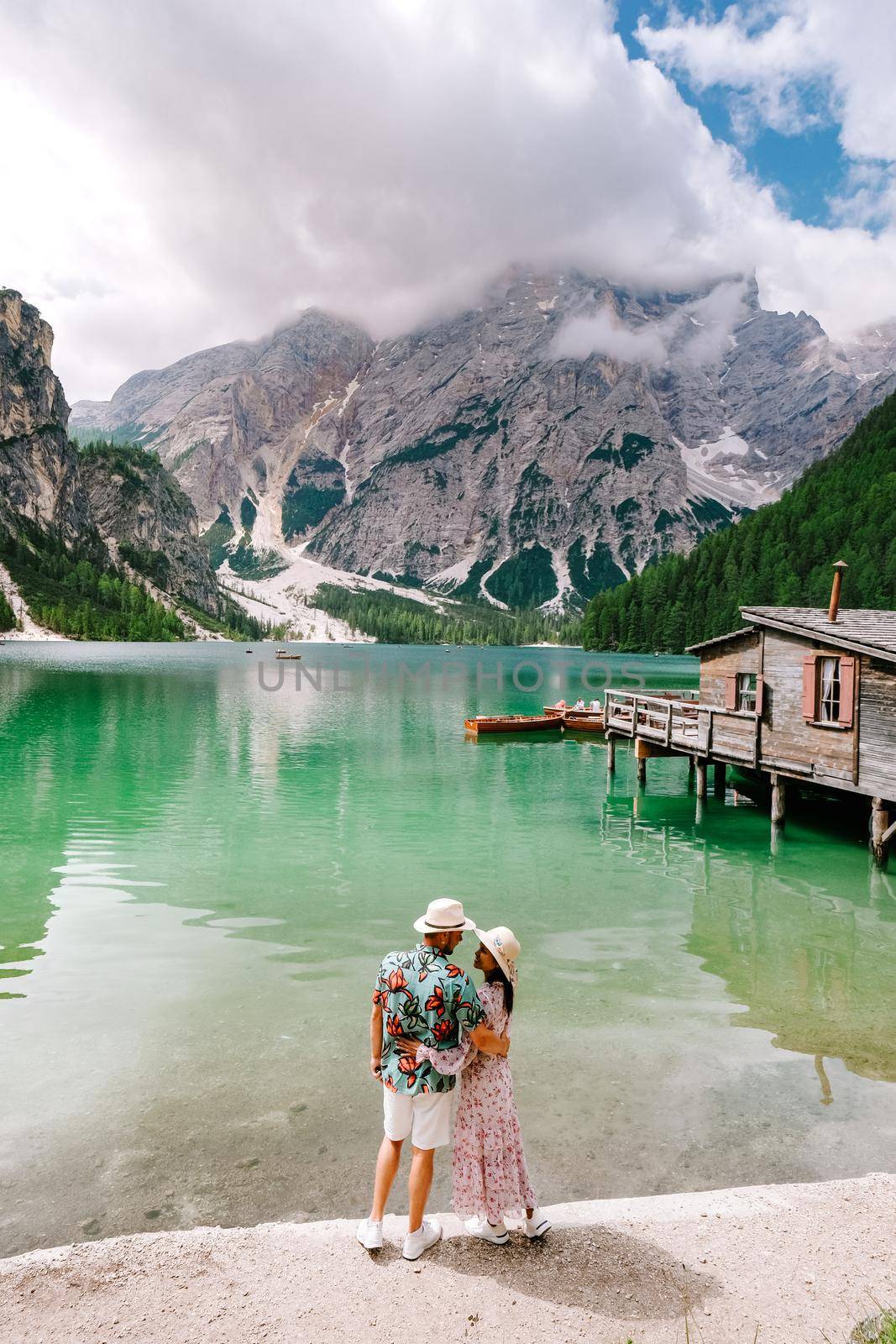 Beautiful lake in the italian alps, Lago di Braies, couple on vacation in the Italian Alps Italy by fokkebok