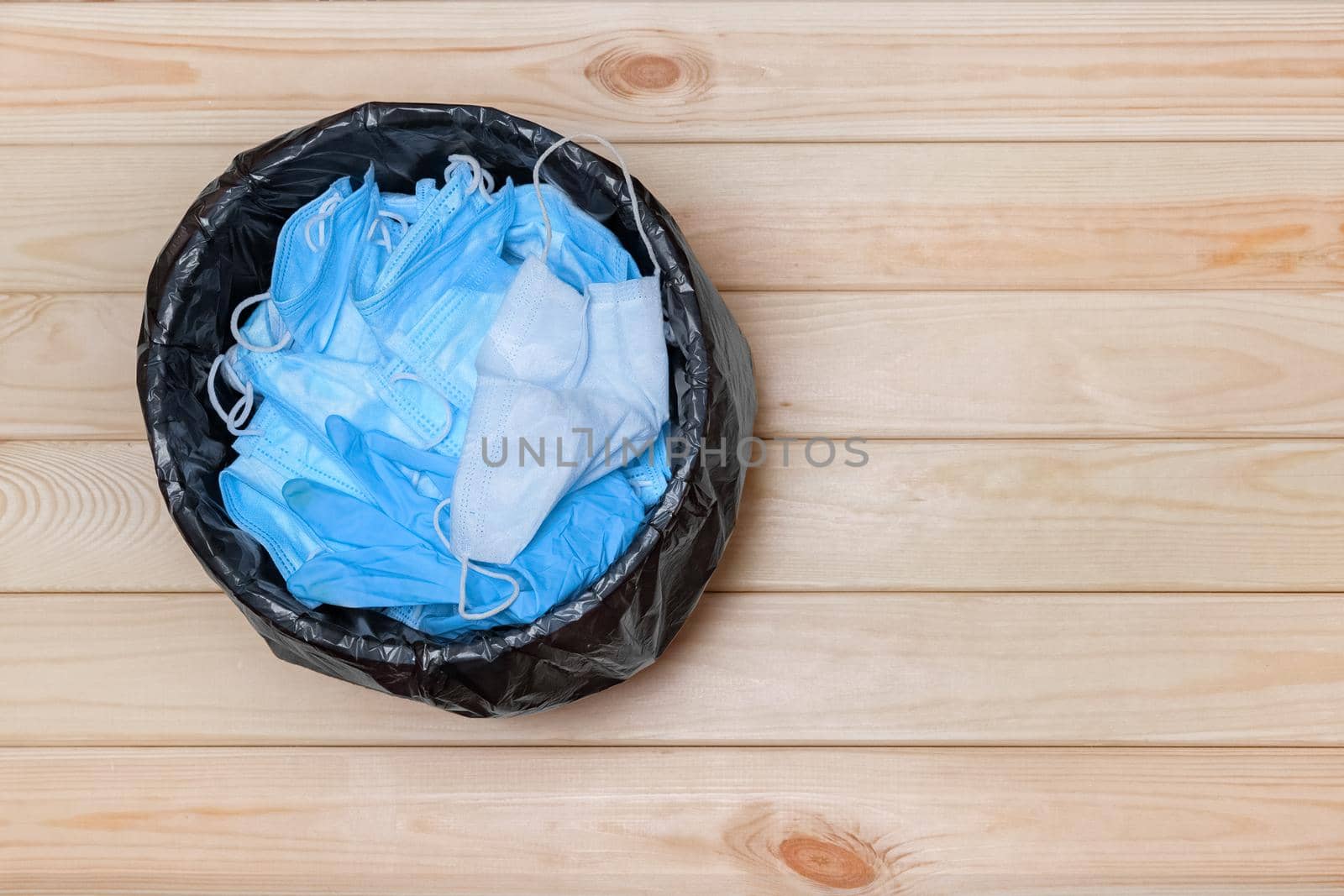 Trash Bin with Masks on Floor, Top View. Used Masks. Disposable Masks in Trash Bucket. Medical Mask after Use. Medical Waste. Used Masks in a Contaminated Waste Bin. Throw Away Used Mask. Coronavirus by synel