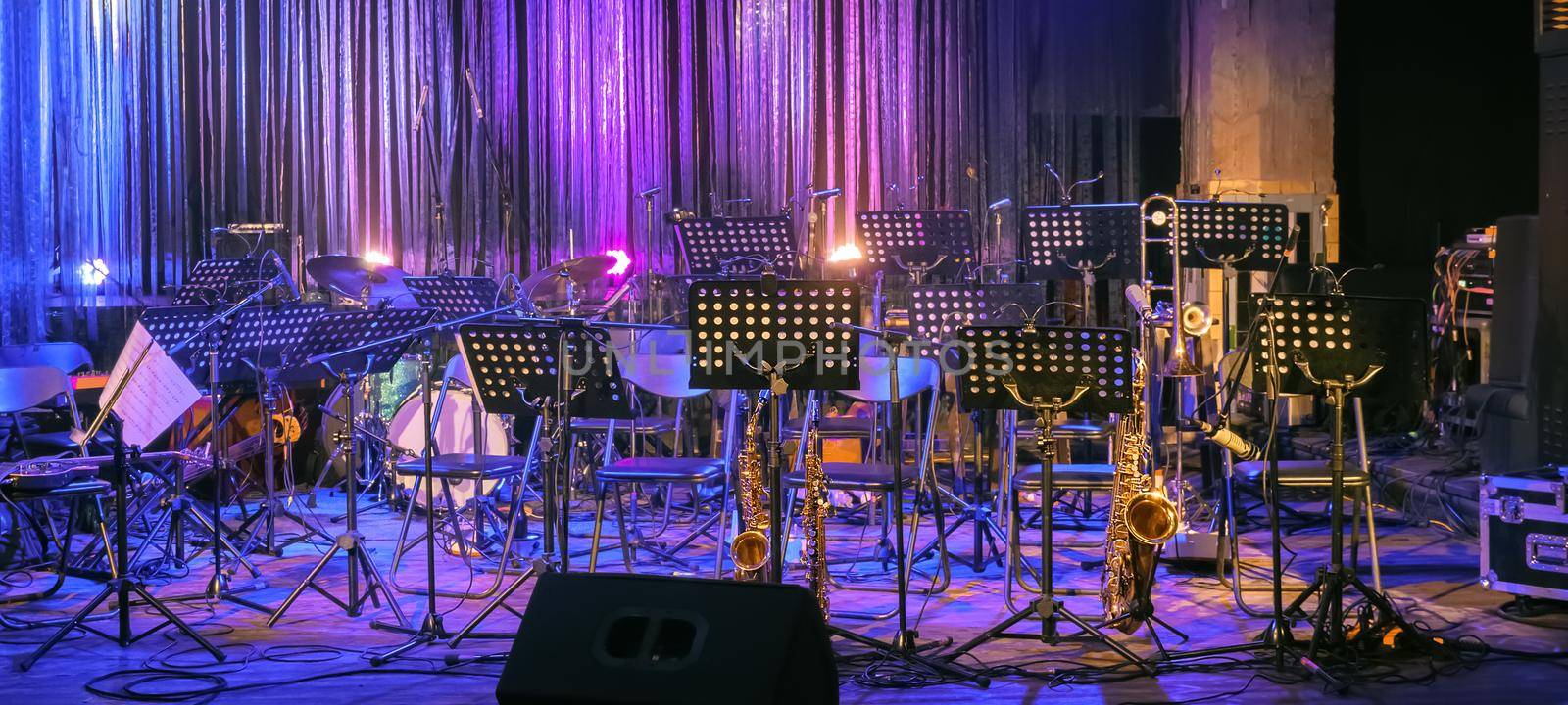 Background for Online Concert. Illuminated Empty Stage for Orchestra. Musical Instruments and Equipment on Stage without People and Musicians. live Music. Event During Coronavirus Pandemic Covid-19