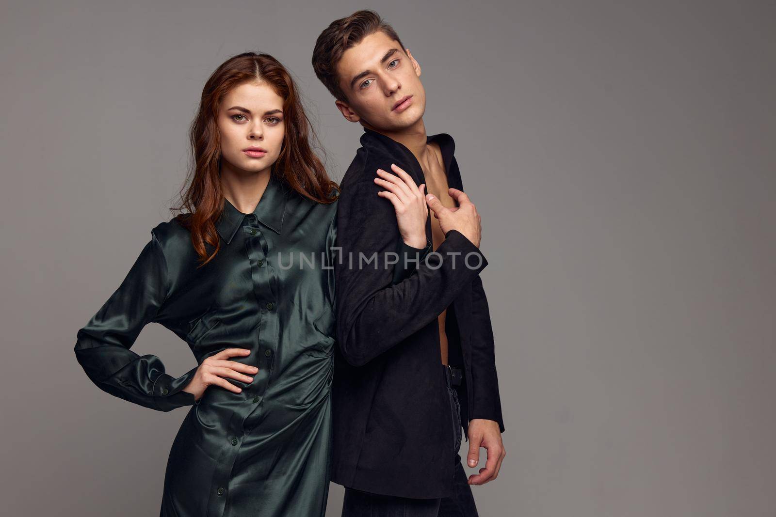 A romantic woman in an evening dress holds the hand of a man in a suit by SHOTPRIME