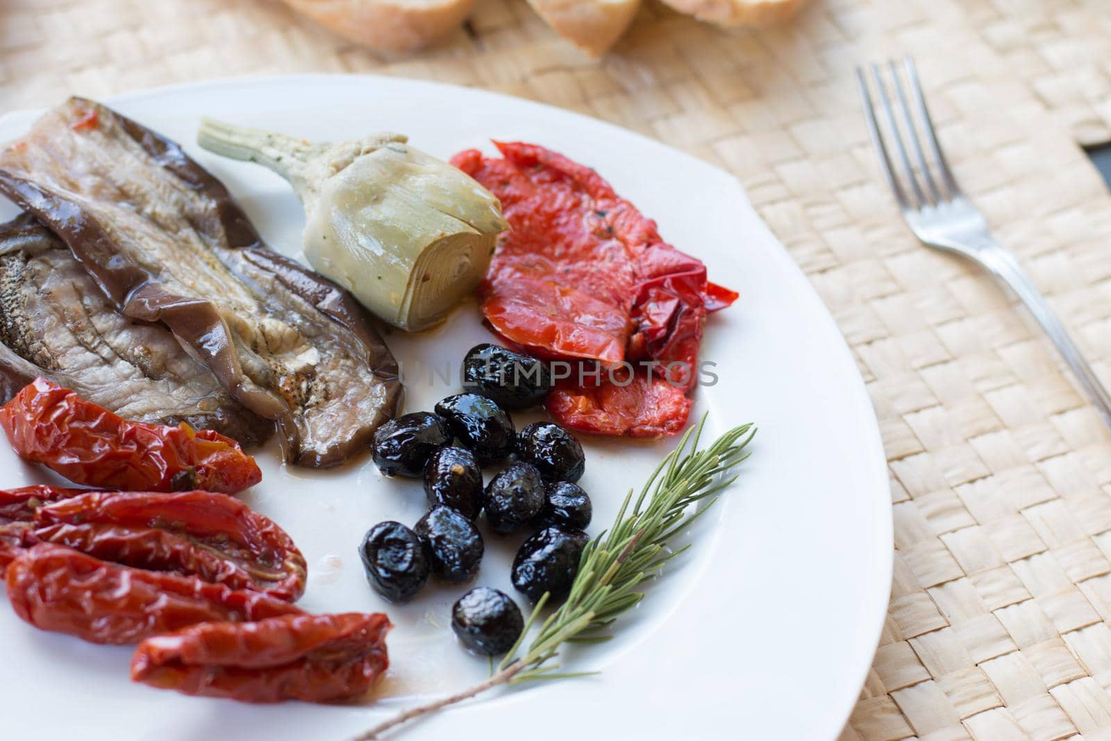 Italian antipasti as dinner appetizer. Tomatoes, Olives, paprika and more.