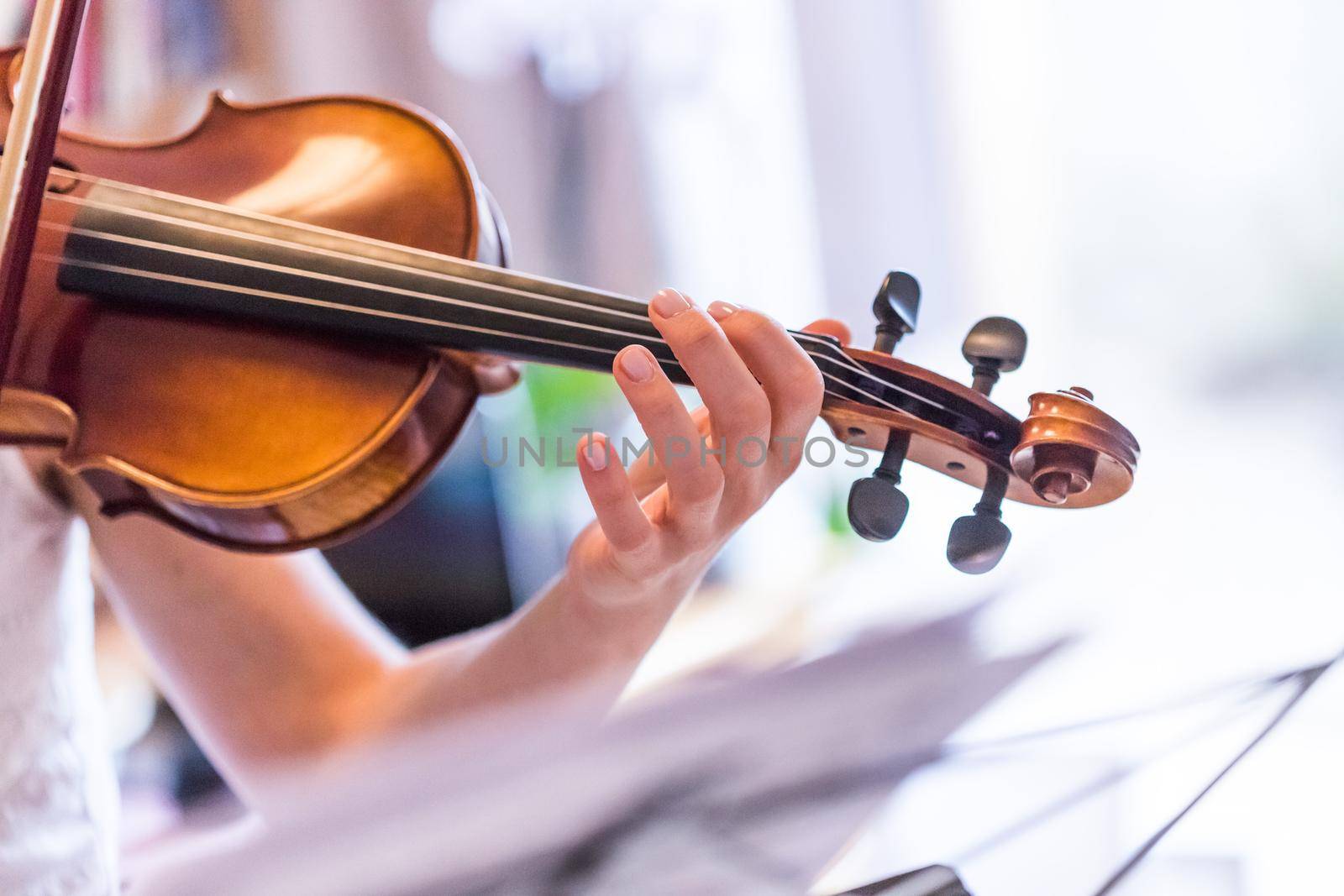 Pretty young girl practices on her violin, acoustic music