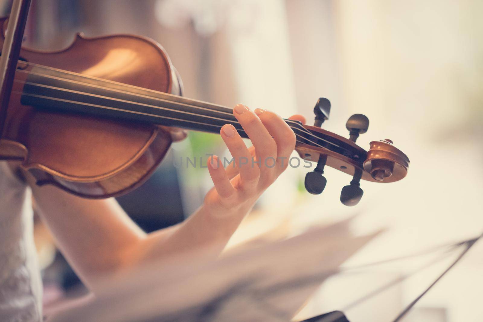 Pretty young girl practices on her violin, acoustic music
