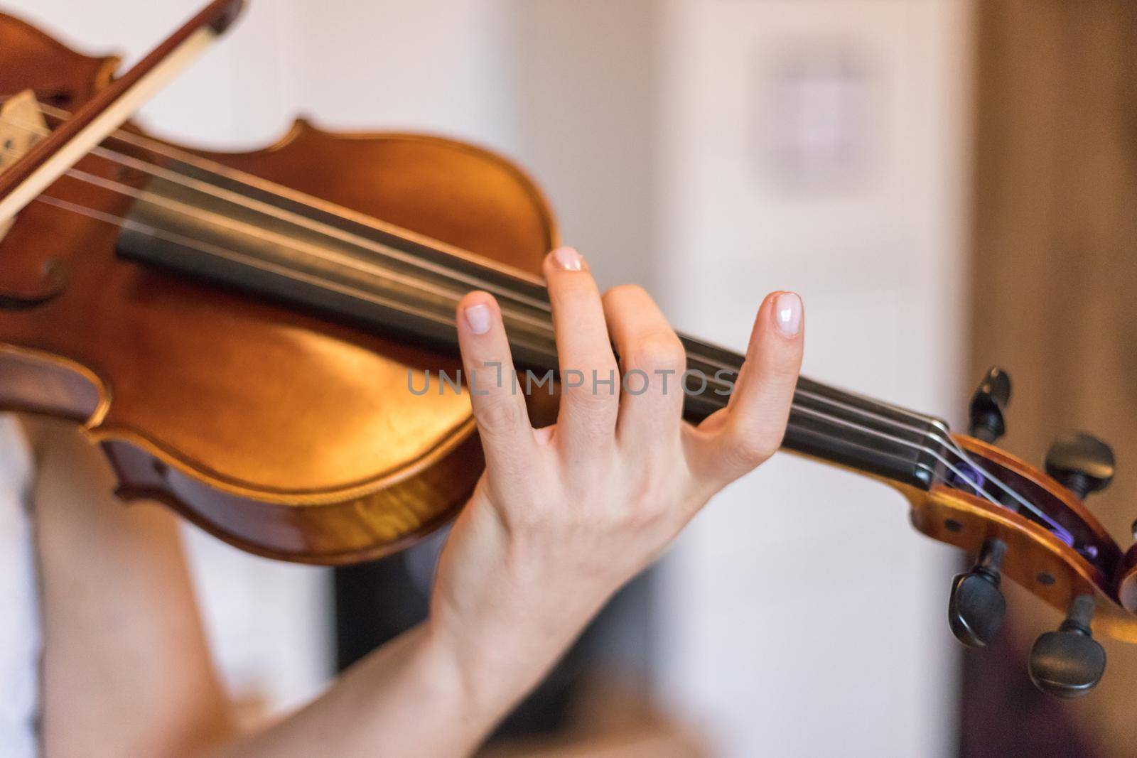 Pretty young girl practices on her violin, acoustic music
