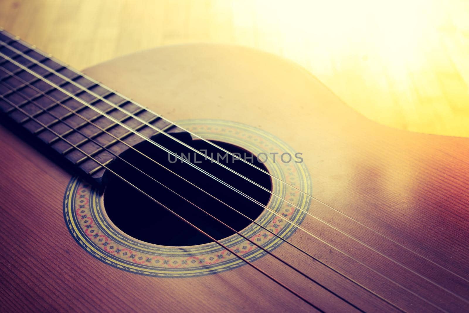 Cutout of a classical guitar corpus and strings, closeup