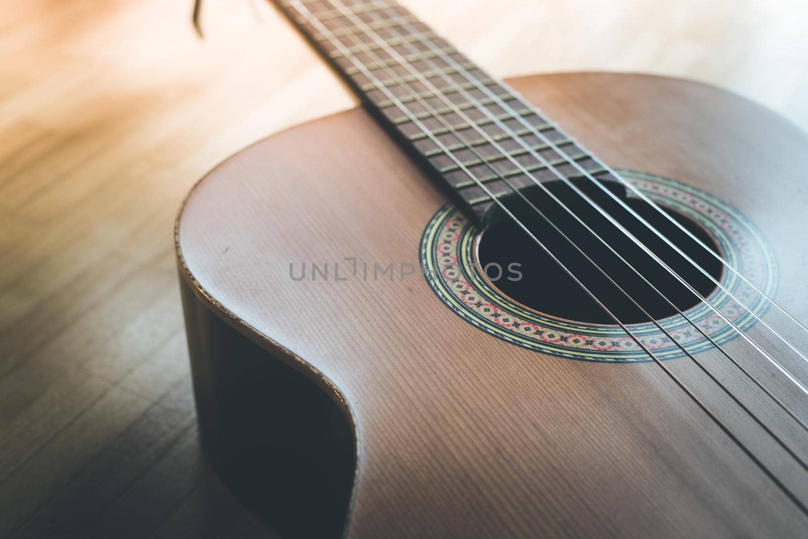 Cutout of a classical guitar corpus and strings, closeup