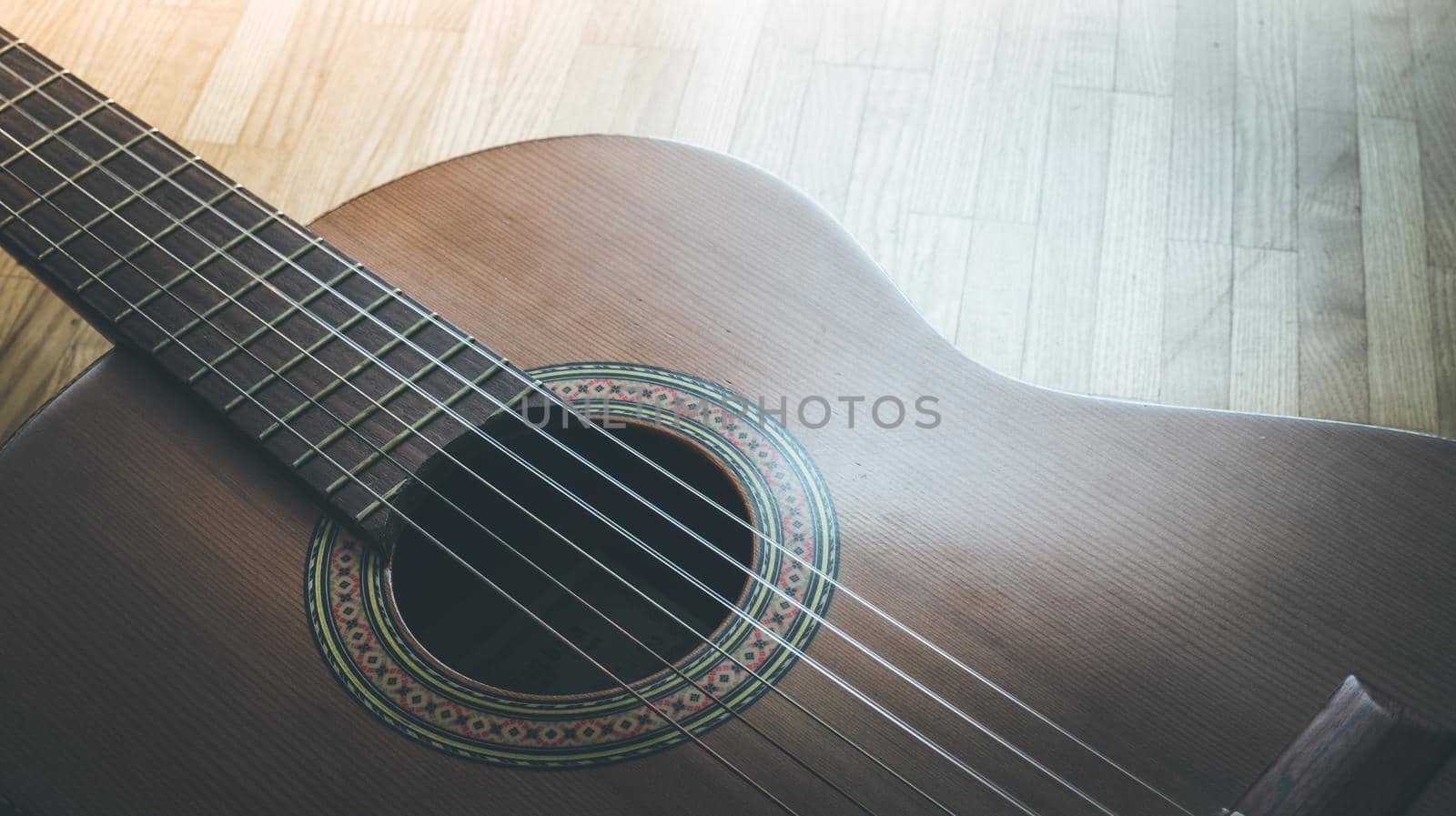 Cutout of a classical guitar corpus and strings, closeup