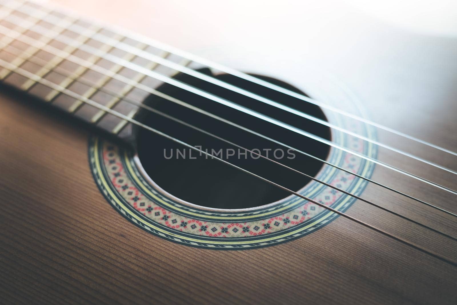 Cutout of a classical guitar corpus and strings, closeup