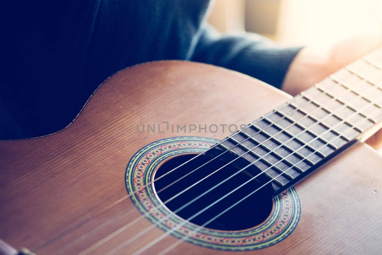 Cutout of a classical guitar corpus and strings, closeup